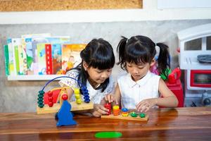 child little girl playing wooden toys photo