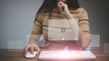 Women using mouse and keyboard for streaming online, watching video on internet, live concert, show or tutorial photo