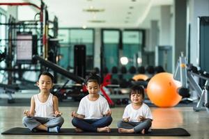 Group of children doing gymnastic exercises photo