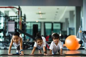 Group of children doing gymnastic exercises photo