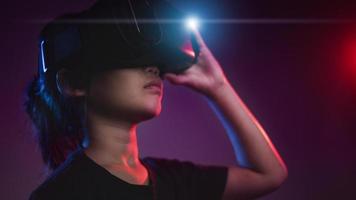 happy girl in glasses of virtual reality. Augmented reality, science, future technology concept. VR. Futuristic 3d glasses with virtual projection. Neon light. photo
