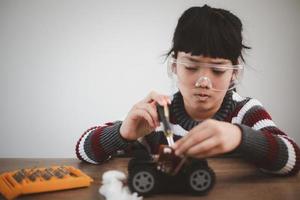 Asia students learn at home in coding robot cars and electronic board cables in STEM, STEAM, mathematics engineering science technology computer code in robotics for kids concept. photo