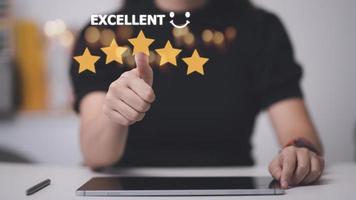 customer hand  with gold five star rating feedback icon and press level excellent rank for giving best score point to review the service, business concept photo