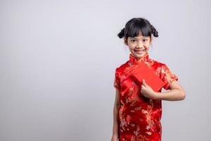 happy Chinese new year. smiling Asian little girls holding red envelope photo