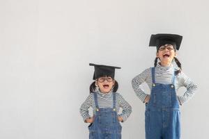 Siblings children girl graduation with cap photo