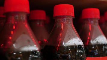 Bottle tops of soda bottles under red flashing light video
