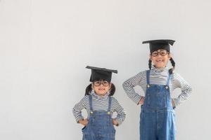 Siblings children girl graduation with cap photo