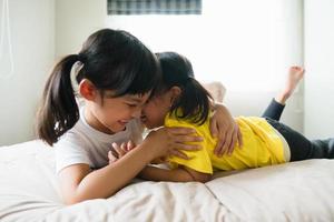 Cute asian children lying on the bed photo