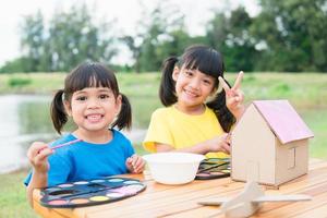 Asian sibling children drawing and painting colouring on the paper photo