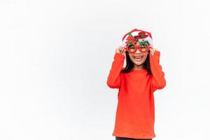 Asian little girl in red Santa hat on white background. photo