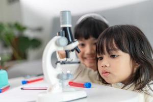 young girl play science experiments for homeschooling photo