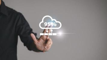 Man doing cloud uploading or downloading on laptop computer at office photo