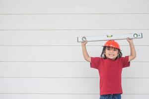 Asian girls pretending to be a construction worker photo