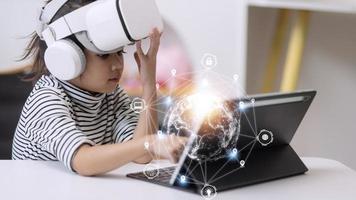 Little girl using VR glasses at home for learning Solar system planets. Modern education science concept. Selective focus. photo