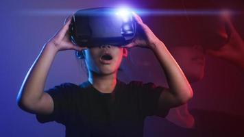 happy girl in glasses of virtual reality. Augmented reality, science, future technology concept. VR. Futuristic 3d glasses with virtual projection. Neon light. photo
