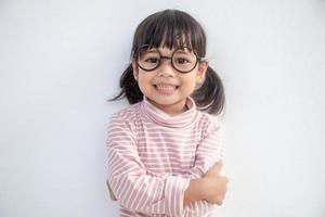 funny Asian child girl wearing glasses on a white background photo