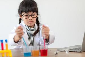 happy little girl with flasks for chemistry photo