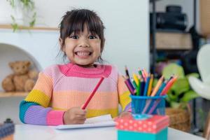 Happy Holidays. Asian little children make cards, gifts, and decorations for the holiday. Cute kids are engaged in creativity. photo