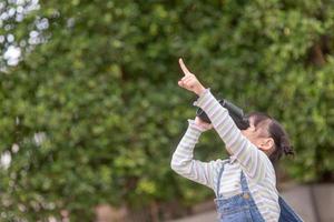 Happy kid looking ahead. Smiling child with the spyglass. Travel and adventure concept. Freedom, vacation photo