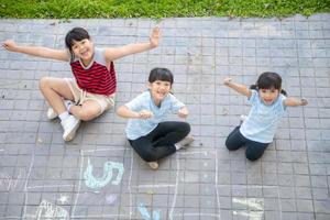 Children playing with colored chalks photo
