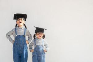 Siblings children girl graduation with cap photo