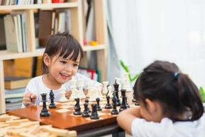 Kids playing chess - one of them just captured a pawn and celebrates photo