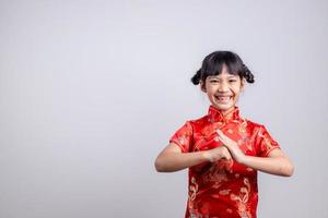 happy Chinese new year. Little Asian girls with Congratulation gesture photo