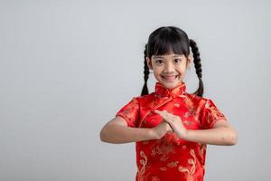 happy Chinese new year. Little Asian girls with Congratulation gesture photo