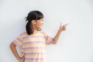 Look There. Student Girl Pointing Fingers At Copy Space Over White Background. photo