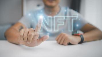 NFT non fungible tokens concept. Businessman touch digital unique art NFT hologram on digital binary background. photo