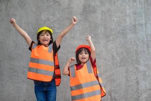 Portrait of sibling girl with a construction hat. photo