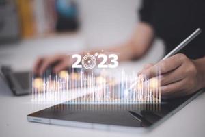 Business and Technology target set goals and achievement in 2023 new year resolution statistics graph rising revenue, planning to start up strategy, icon concept photo