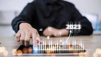 Business and Technology target set goals and achievement in 2023 new year resolution statistics graph rising revenue, planning to start up strategy, icon concept photo