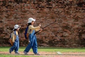 Two Asian children girls are bloggers. Broadcast on the Internet. Record vlog and blog subscribers. Record video lessons for Internet. Use camera with tripod. photo