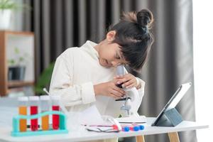 young girl play science experiments for homeschooling photo