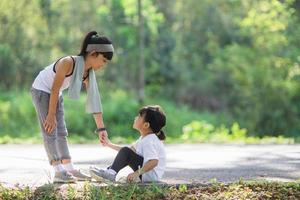 Cute asian girl give hand to help sister accident during running photo