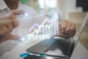 The concept of big data analytics and business intelligence. On a virtual screen, there are financial charts. photo