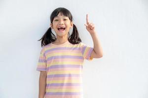 Asian student girl over white background pointing finger up with a successful idea. Excited and happy. Number on photo