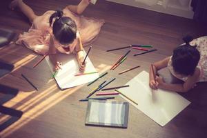 Kids drawing on floor on paper.vintage color photo