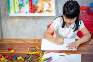 Preschooler child girl drawing and coloring photo