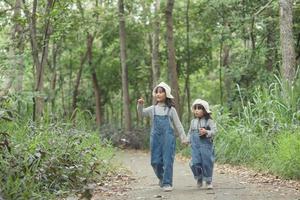 Children are heading to the family campsite in the forest Walk along the tourist route. Camping road. Family travel vacation concept. photo