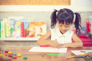 Preschooler child girl drawing and coloring photo
