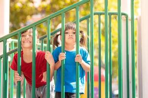 Child playing on the outdoor playground. Kids play in school or kindergarten yard. photo