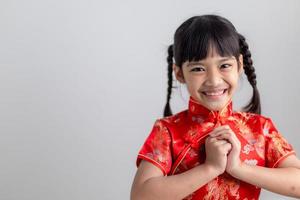 happy Chinese new year. Little Asian girls with Congratulation gesture photo