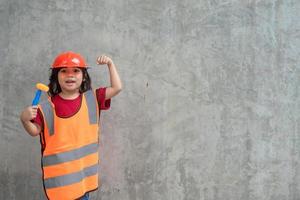 Asian girl children playing as an engineer helmet photo