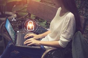 Business, technology, internet and networking concept. businesswoman working on his laptop at home, select the icon security on the virtual screen. photo