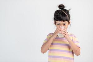 Smiling of Asian girl with a glass of milk photo