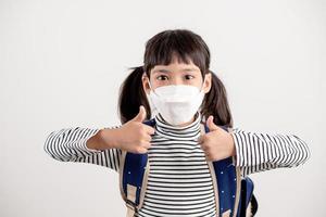 Child with face mask going back to school after covid-19 quarantine and lockdown. photo