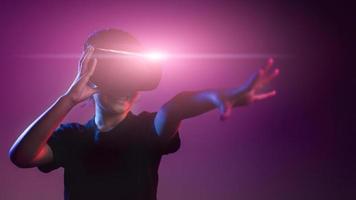 happy girl in glasses of virtual reality. Augmented reality, science, future technology concept. VR. Futuristic 3d glasses with virtual projection. Neon light. photo