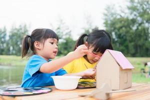 Asian sibling children drawing and painting colouring on the paper photo